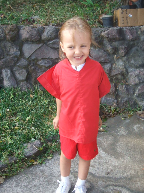 My kiddo in his new art smock. The color of the smock even matches his school uniform!